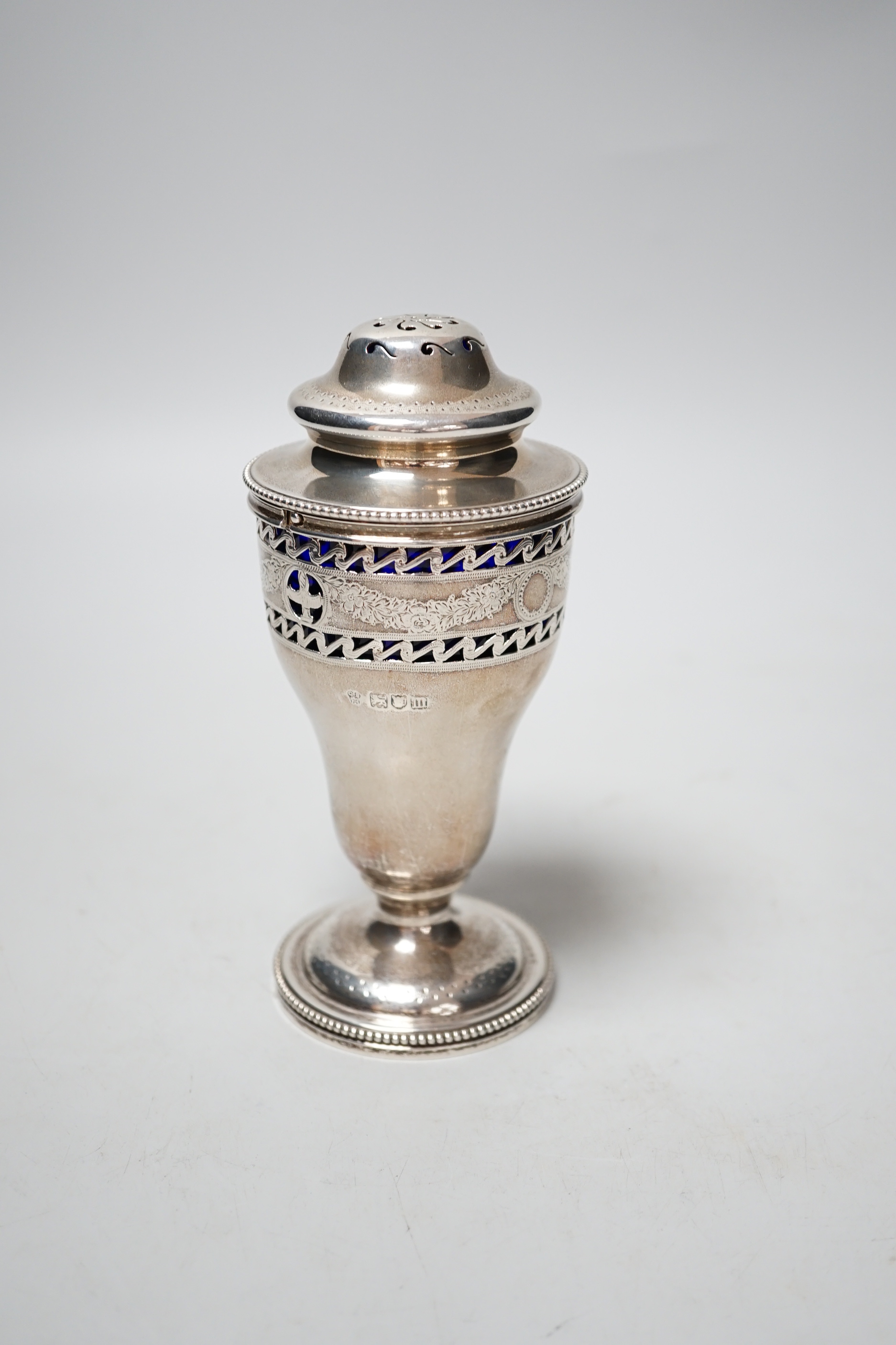 An Edwardian pierced silver sugar sifter, with blue glass liner, Charles Stuart Harris & Sons, London, 1907, 15.2cm.